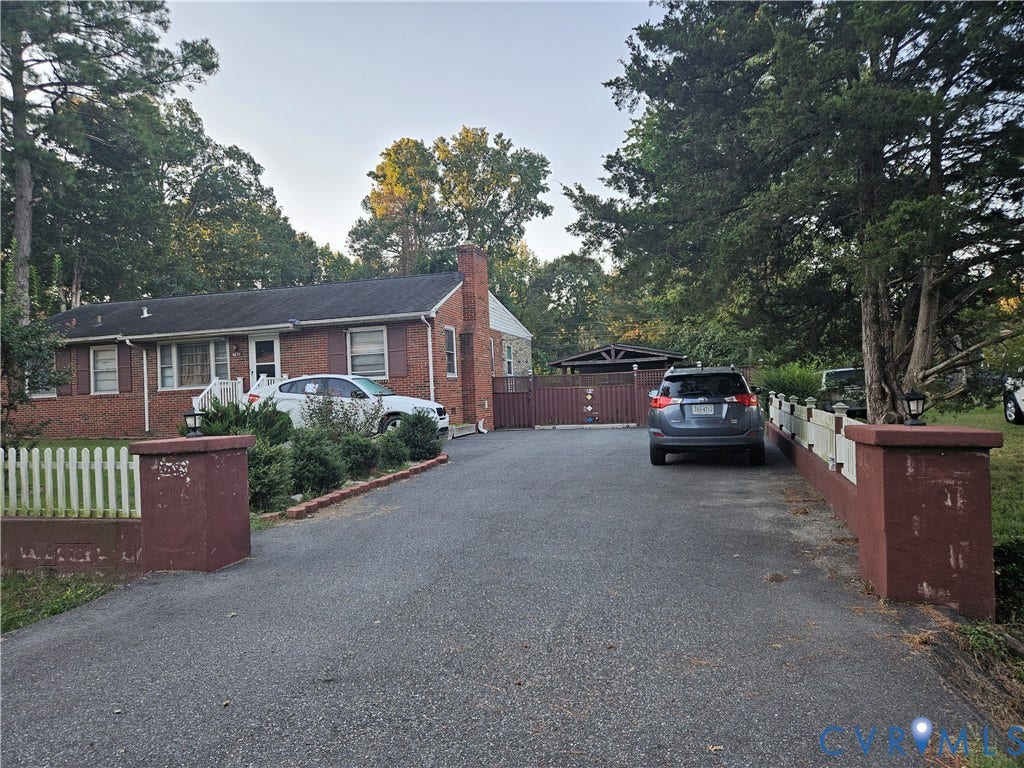 Brick exterior residence with a charcoal shingle roof