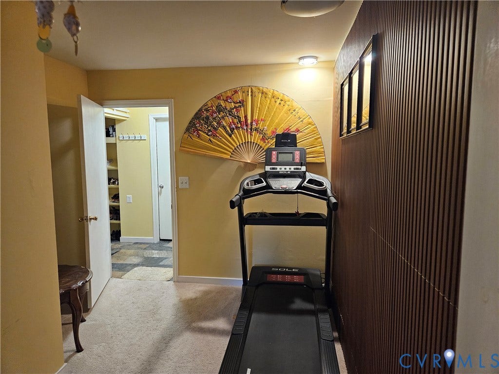 Carpeted flooring, recessed lighting, and wall paneling