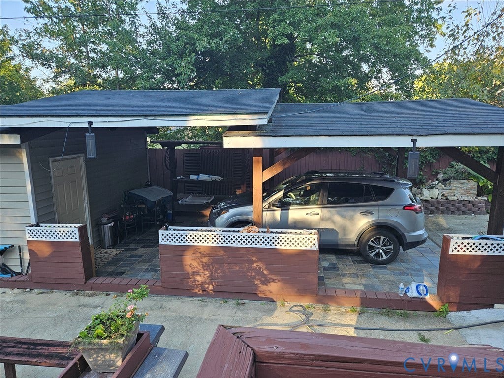 Covered patio area featuring a paver stone surface