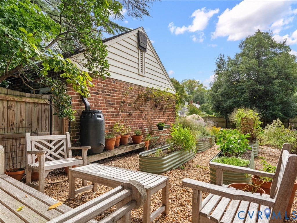 Tucked behind the garage is another space to relax or garden in these raised beds.