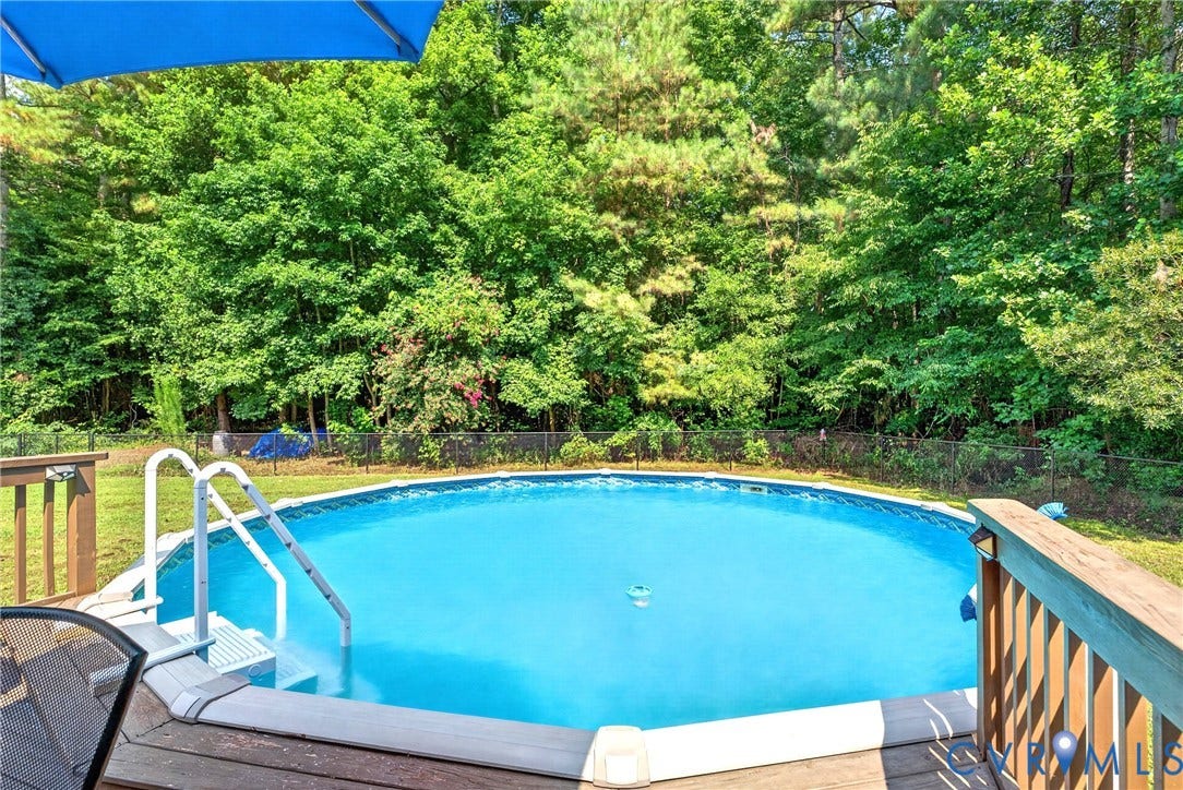 Above-ground pool with a surrounding wood deck
