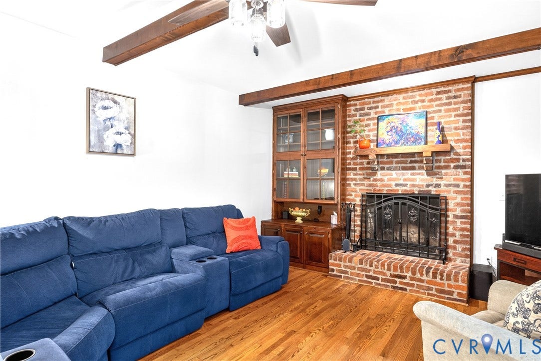 Brick fireplace with a black metal screen