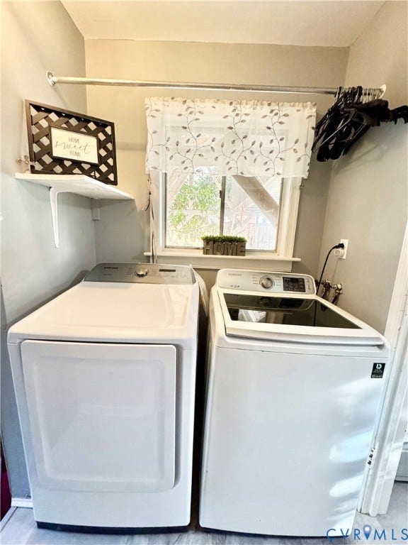 Laundry area featuring a window, built-in shelving, and a hanging rod