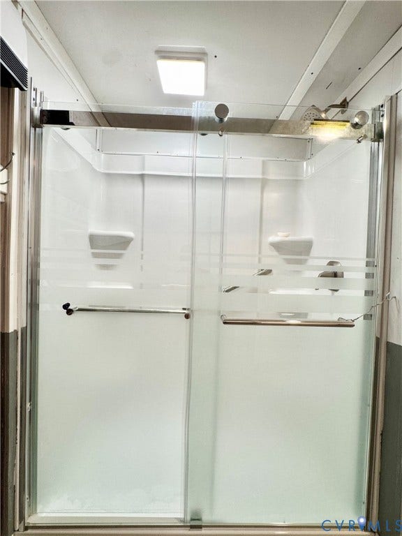 Frosted glass shower enclosure with sliding doors and chrome hardware
