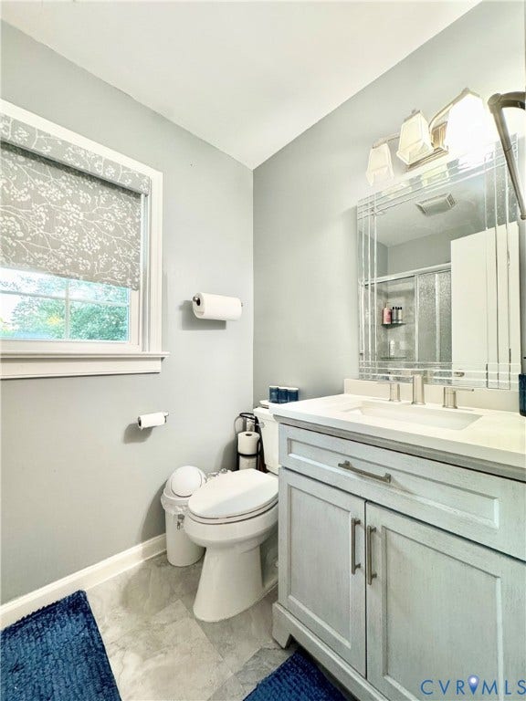 Single vanity with integrated sink, brushed nickel faucet, and under-cabinet storage