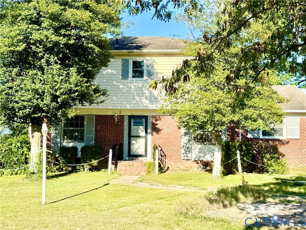 Brick and siding exterior with mature trees