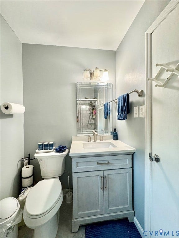 Powder room featuring a single vanity with a light gray cabinet, white countertop, and an undermount sink