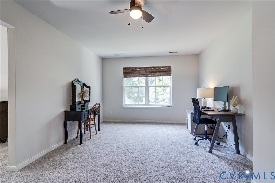 Recessed lighting, ceiling fan, natural light from a window, and light-toned carpeting