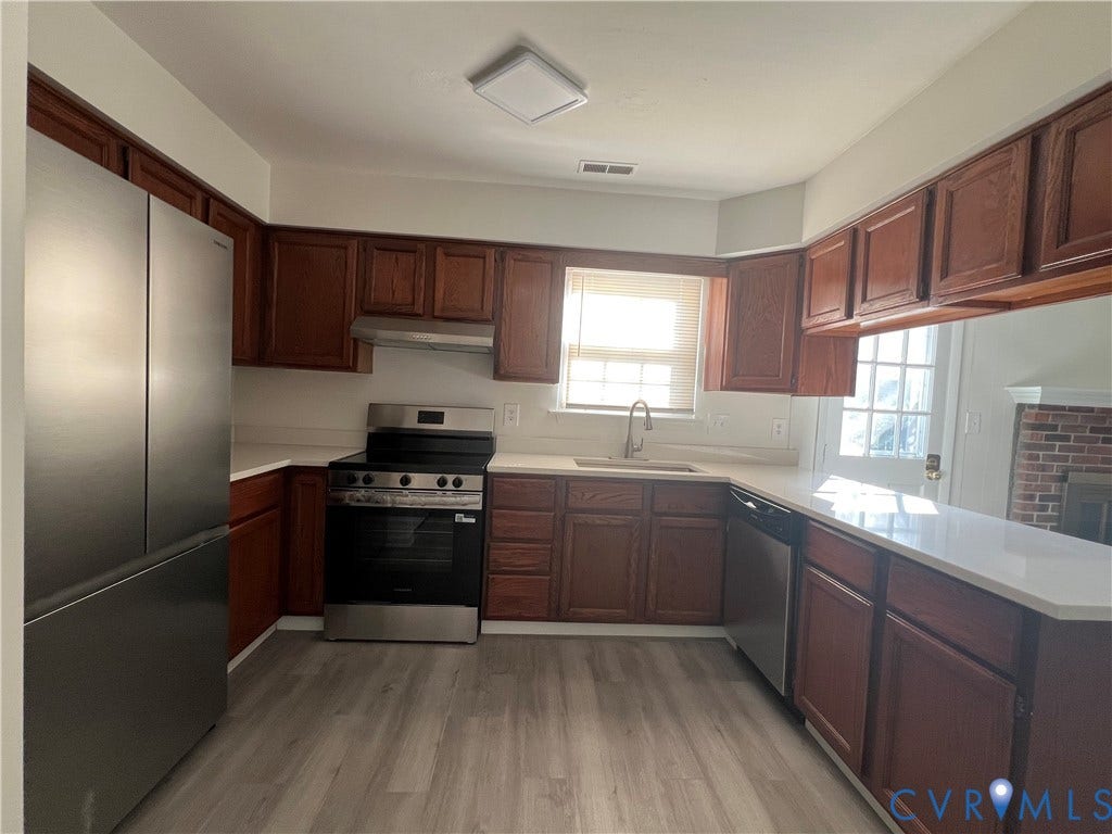 2112 Paramont Avenue, Collegue Park, Chesapeake, VA 23320 Kitchen featuring wood-finish cabinetry, light-toned countertops, and stainless steel appliances
