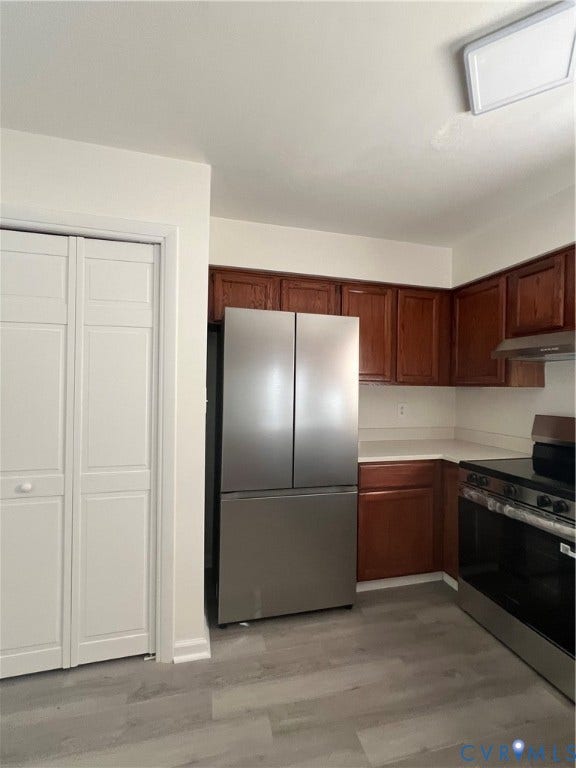 2112 Paramont Avenue, Collegue Park, Chesapeake, VA 23320 Wood-finish flooring, stainless steel French door refrigerator, wood-finish cabinetry, stainless steel range with overhead hood, and white countertops