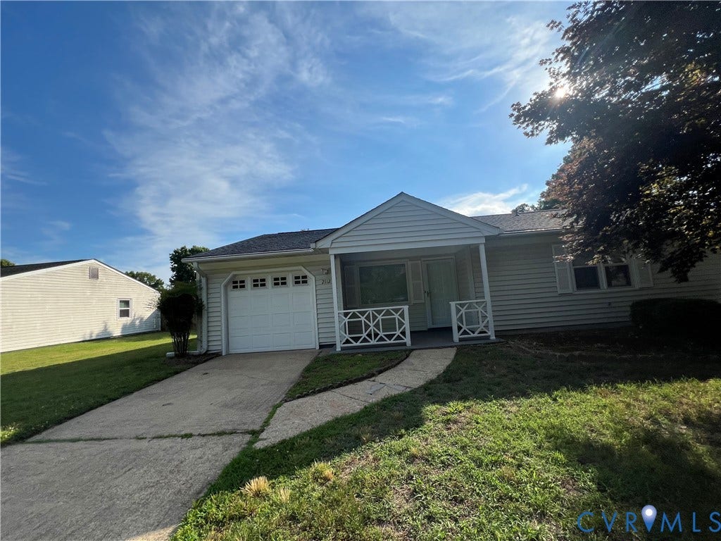 2112 Paramont Avenue, Collegue Park, Chesapeake, VA 23320 White siding exterior with a covered front porch featuring decorative railings, an attached single-car garage, and a paved driveway