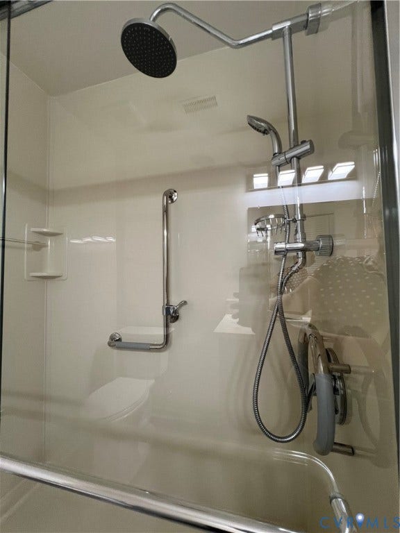 2112 Paramont Avenue, Collegue Park, Chesapeake, VA 23320 Walk-in shower featuring a fixed shower head, handheld shower, and grab bars