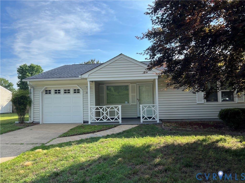 2112 Paramont Avenue, Collegue Park, Chesapeake, VA 23320 Light-colored siding exterior with a dark shingle roof, integrated garage, and a covered front porch featuring decorative white railings