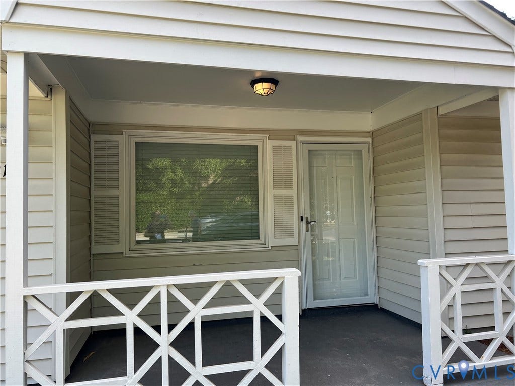 2112 Paramont Avenue, Collegue Park, Chesapeake, VA 23320 Covered entry with shiplap siding, decorative porch railing, and a multi-pane window with louvered shutters