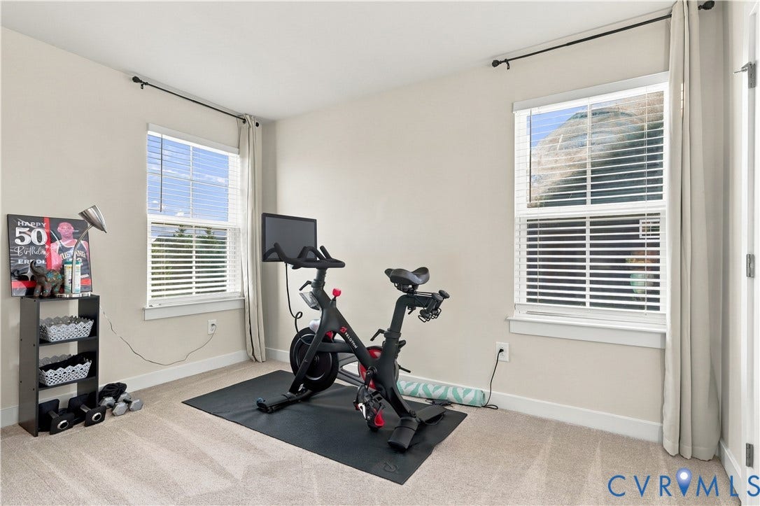 Neutral-toned walls complement the carpeted flooring