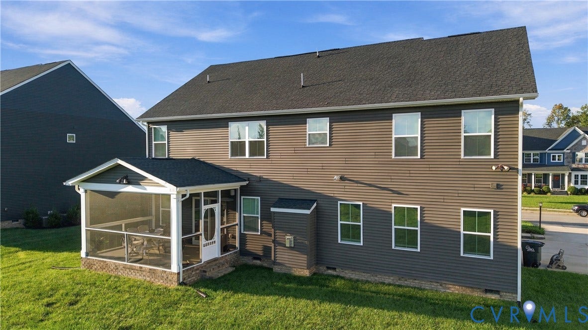 Two-story residence featuring horizontal siding and a dark shingle roof