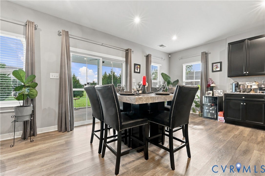 Wood-finish flooring, recessed lighting, and a sliding glass door