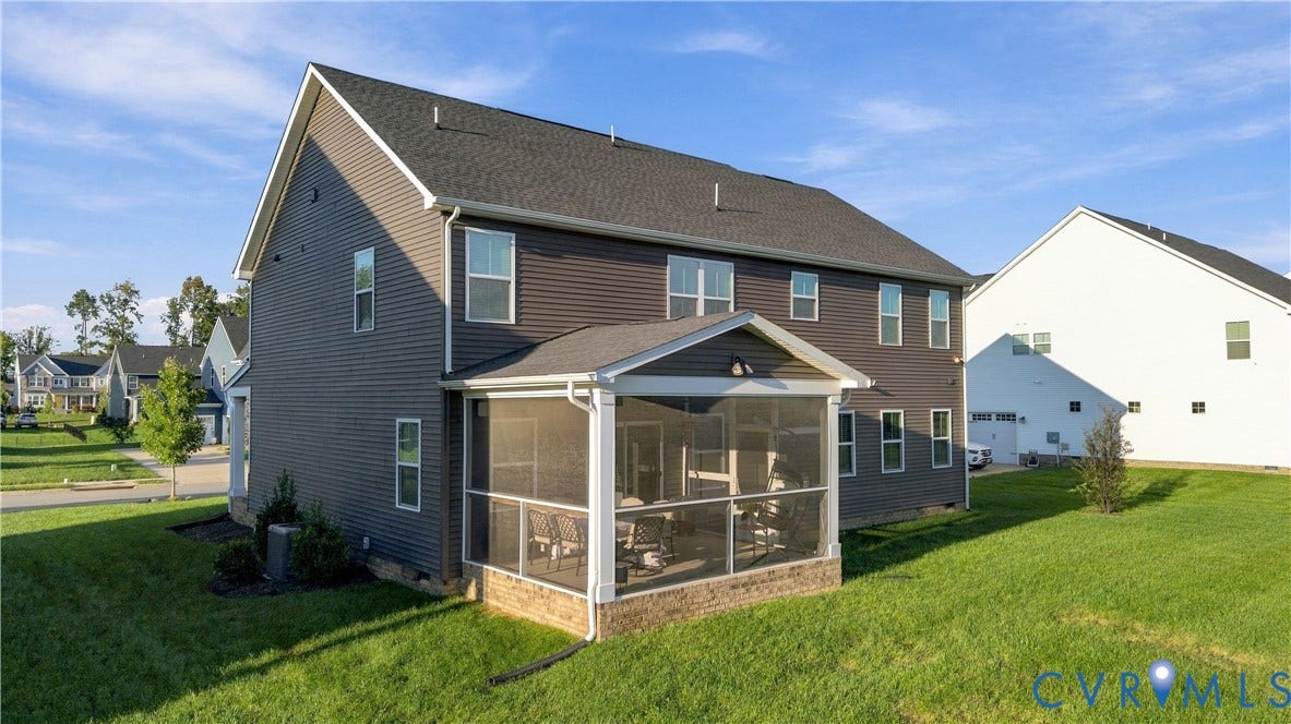 Two-story residence featuring a screened porch with brick-finish foundation