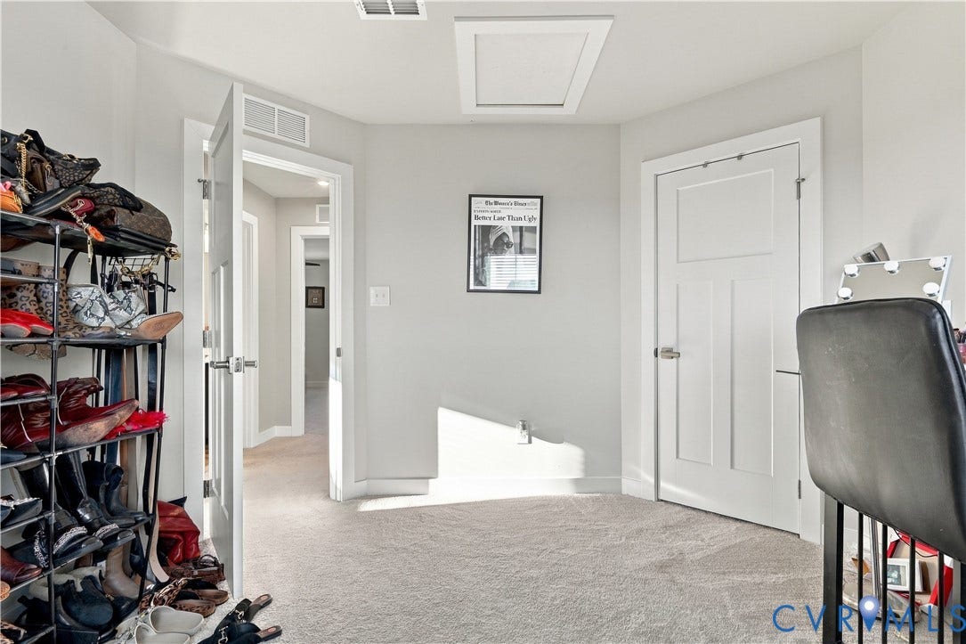 White paneled doors, light gray wall paint, and light-toned carpeting