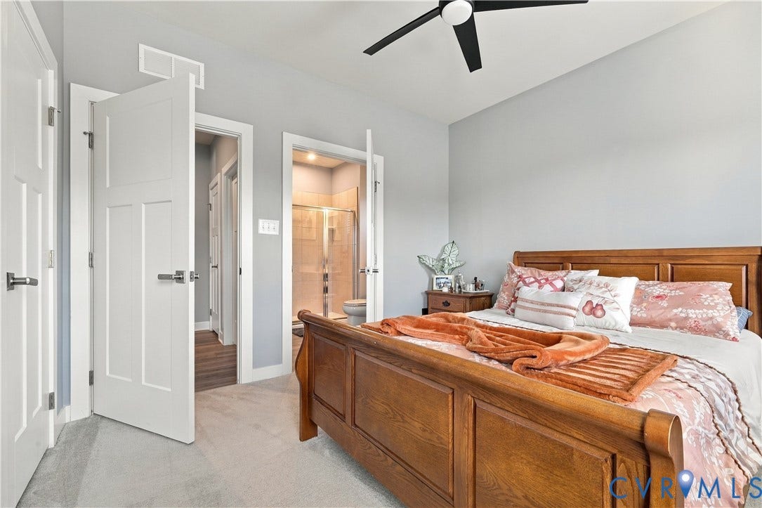 Carpeted flooring with light gray walls, a ceiling fan, and white paneled doors