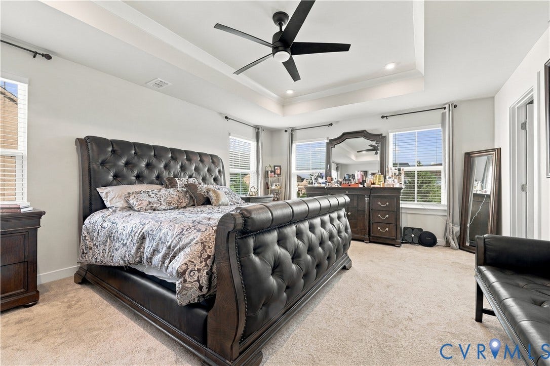 Tray ceiling with recessed lighting and a ceiling fan