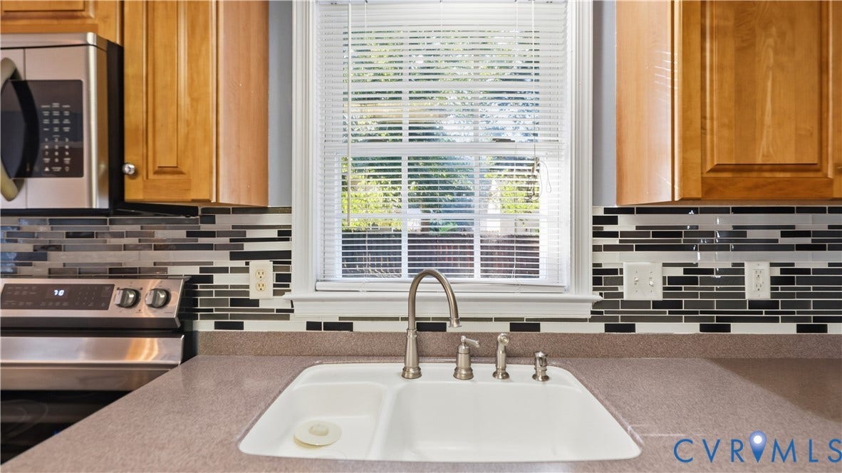 Double basin sink with brushed nickel faucet, set in a neutral-toned countertop