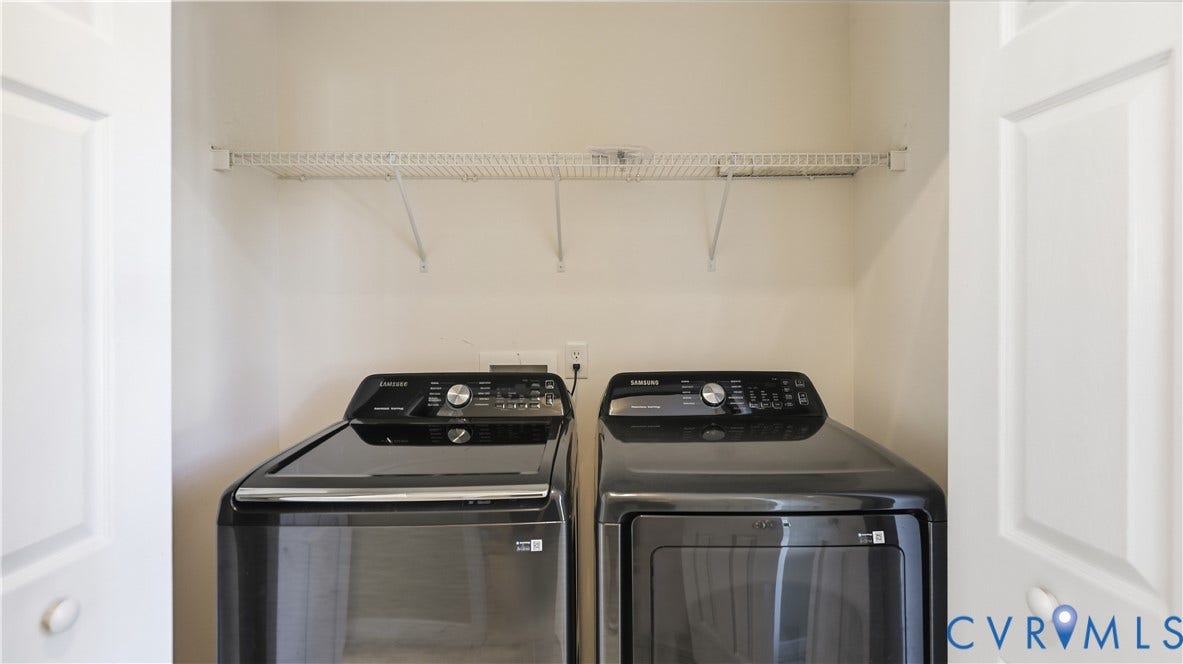 Laundry closet featuring a wire storage shelf and white panel doors