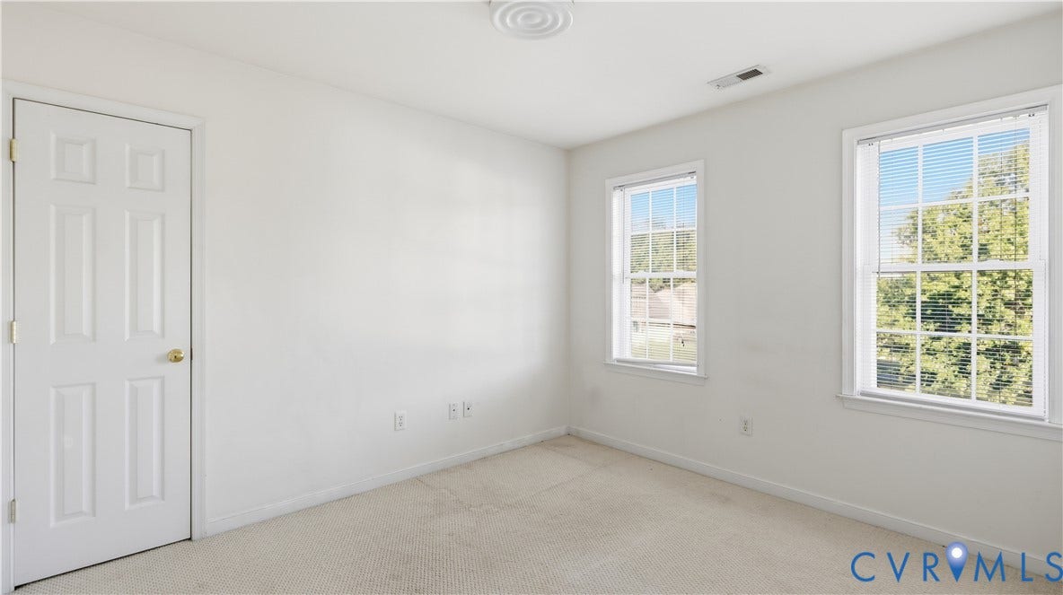 White paneled interior door with gold-tone hardware