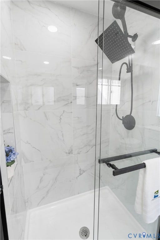 4911 Aqua Lane, Prince George, VA 23875 Glass-enclosed shower with white tiled walls and a rain shower head
