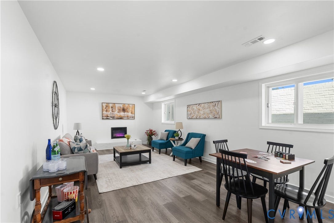 4911 Aqua Lane, Prince George, VA 23875 Recessed lighting illuminates the open-concept space, featuring wood-finish flooring and an electric fireplace