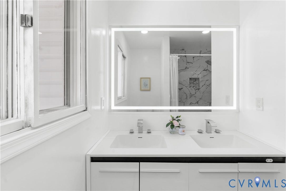 4911 Aqua Lane, Prince George, VA 23875 Dual undermount sinks with chrome faucets, illuminated mirror, and a window providing natural light