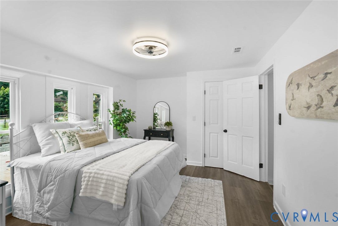 4911 Aqua Lane, Prince George, VA 23875 Wood-finish flooring, white paneled doors, ceiling-mounted light fixture, white walls, and multiple windows