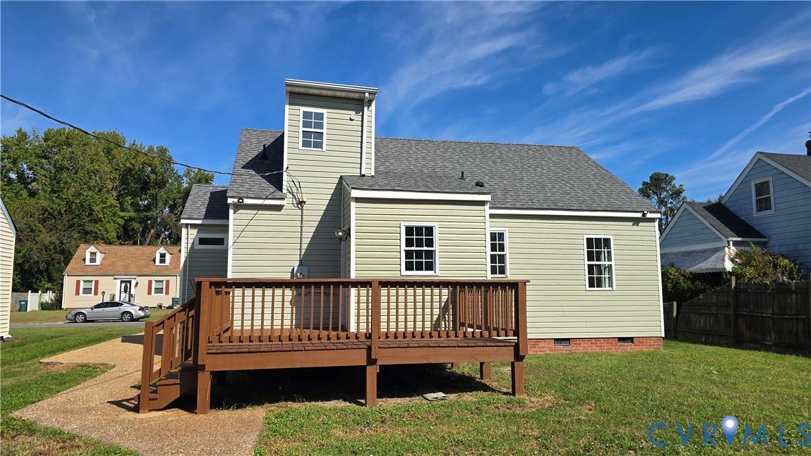 Wood deck with steps, light green siding, white-framed windows, and a gray shingle roof