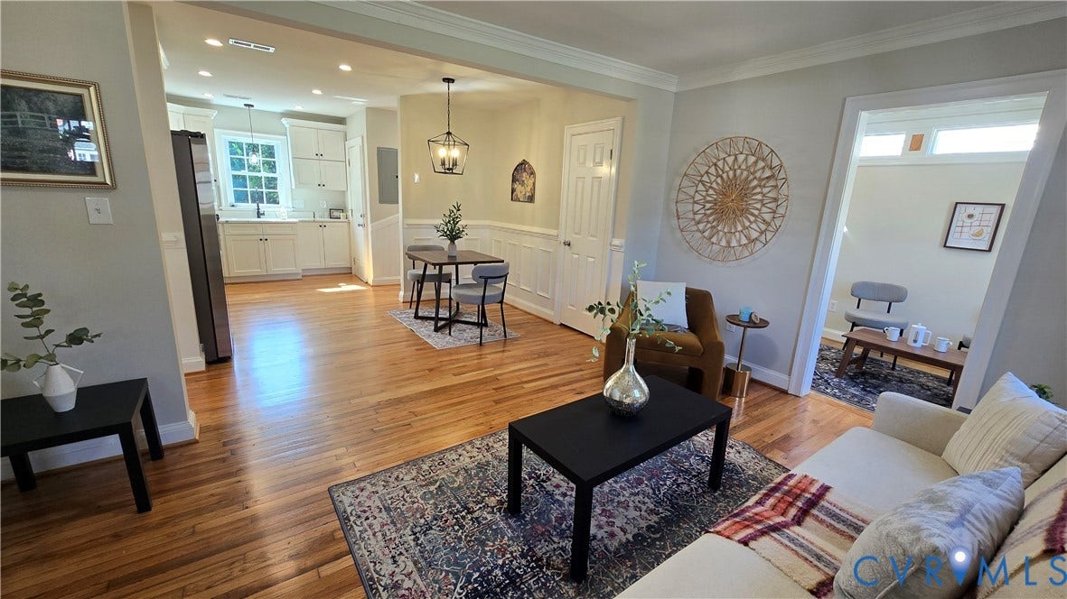 Hardwood flooring throughout, white shaker kitchen cabinetry, stainless steel appliances, recessed lighting, and crown molding