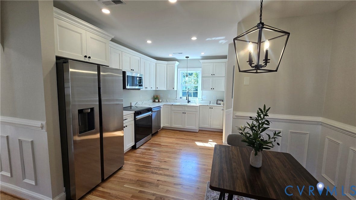 Kitchen featuring white shaker cabinetry, stainless steel appliances, recessed lighting, and wood-finish flooring
