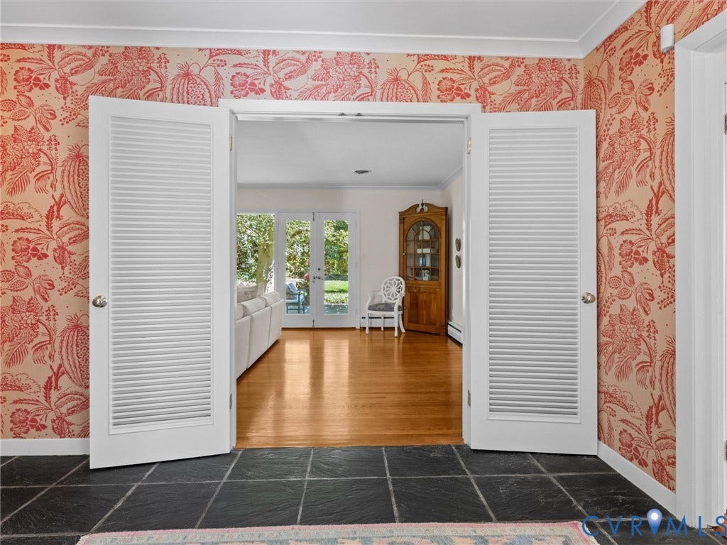 6208 Tapoan Place, Three Chopt, Richmond, VA 23226 Black slate tile flooring, louvered double doors, red and white floral wallpaper, and hardwood flooring
