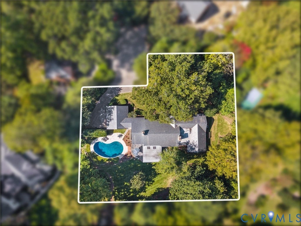 6208 Tapoan Place, Three Chopt, Richmond, VA 23226 Aerial property overview featuring a dark shingle roof, a kidney-shaped swimming pool, a surrounding patio, and mature trees
