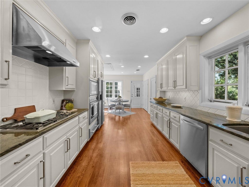 6208 Tapoan Place, Three Chopt, Richmond, VA 23226 Galley kitchen featuring white cabinetry, dark countertops, wood-finish flooring, recessed lighting, and stainless steel appliances