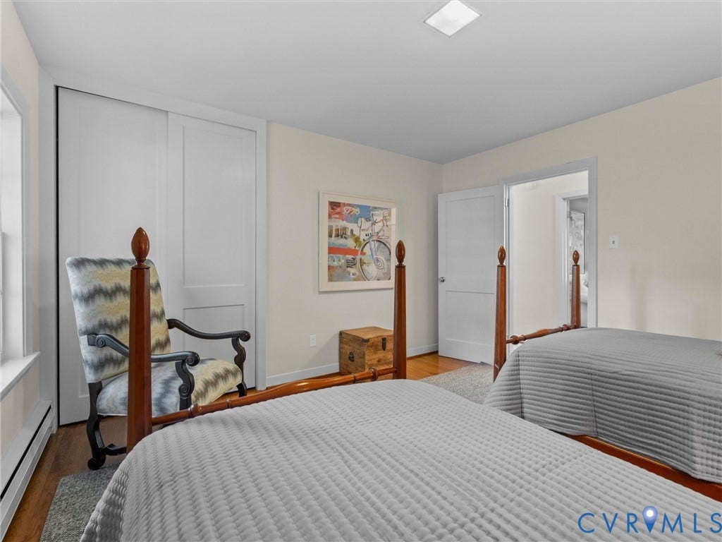 6208 Tapoan Place, Three Chopt, Richmond, VA 23226 Warm wood-finish flooring with a light-toned area rug, white bi-fold closet doors, white interior door, and recessed lighting