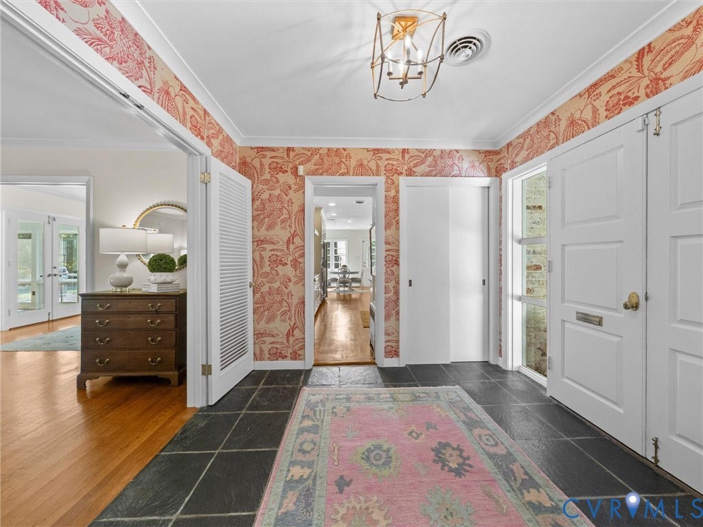 6208 Tapoan Place, Three Chopt, Richmond, VA 23226 Slate tile flooring, decorative wallpaper, brass-finish ceiling light fixture, white interior doors, and crown molding