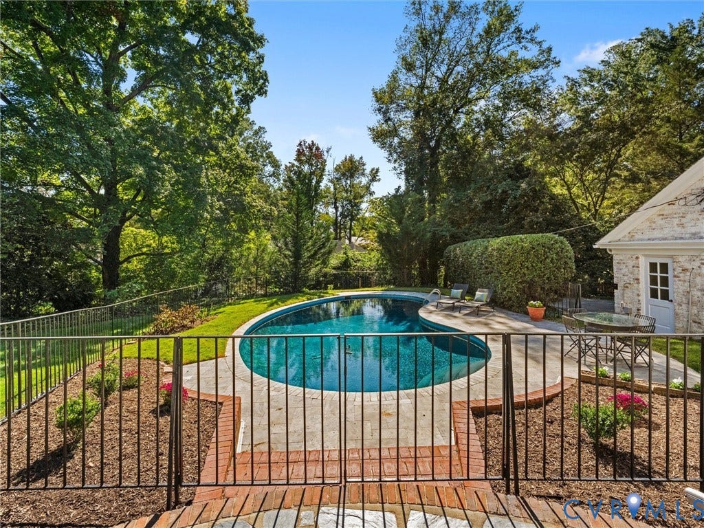 6208 Tapoan Place, Three Chopt, Richmond, VA 23226 In-ground swimming pool with a curved edge, surrounded by a stone patio and brick accents
