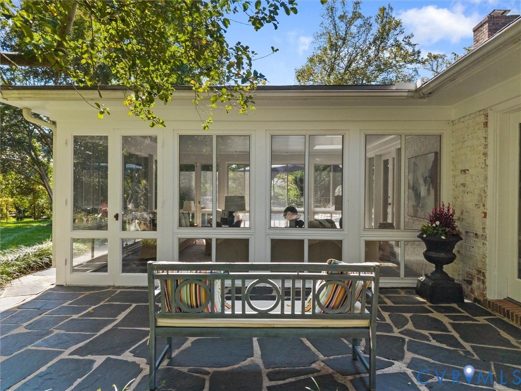 6208 Tapoan Place, Three Chopt, Richmond, VA 23226 Expansive flagstone patio with a white-framed sunroom and painted brick exterior