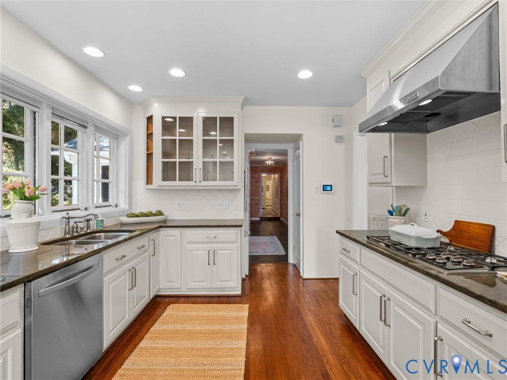6208 Tapoan Place, Three Chopt, Richmond, VA 23226 Well-appointed kitchen featuring white cabinetry, dark stone countertops, stainless steel appliances, and wood-finish flooring