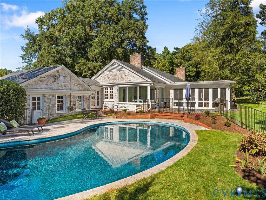 6208 Tapoan Place, Three Chopt, Richmond, VA 23226 Stone exterior with multiple rooflines, featuring a curved swimming pool with a paved surround