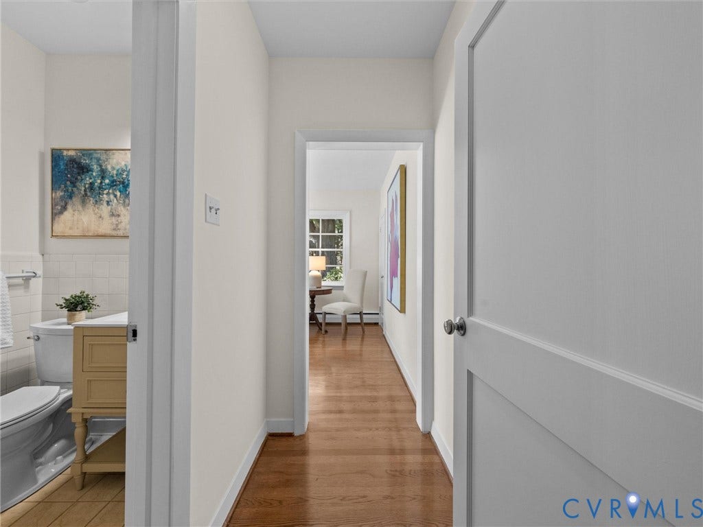 6208 Tapoan Place, Three Chopt, Richmond, VA 23226 Bright hallway with wood-finish flooring, white panel doors, and neutral wall finishes