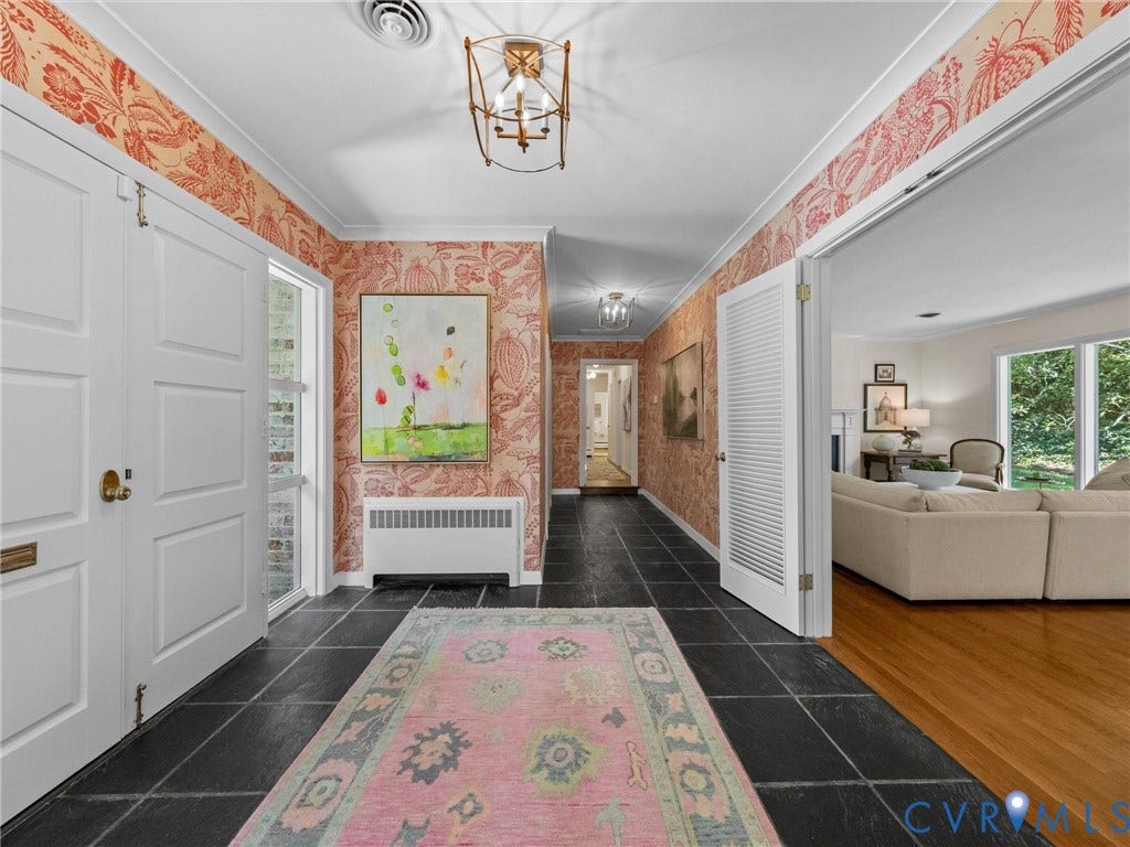 6208 Tapoan Place, Three Chopt, Richmond, VA 23226 Black square-tiled flooring, patterned wall covering, a white paneled entry door, a white slatted door, and a decorative ceiling light fixture