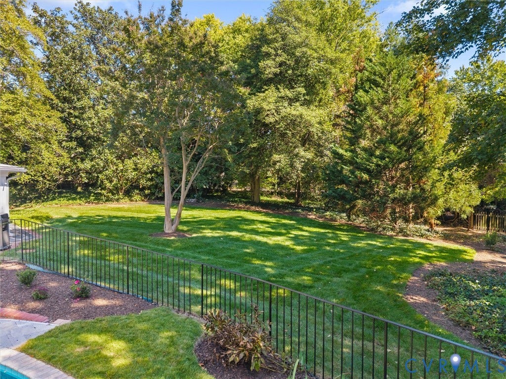 6208 Tapoan Place, Three Chopt, Richmond, VA 23226 Expansive backyard featuring a manicured lawn, mature trees, and a decorative metal fence