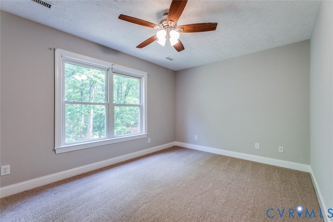 Neutral-toned walls complement a textured carpeted floor