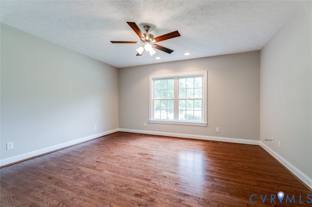 Hardwood flooring, neutral wall paint, recessed lighting, ceiling fan with light, and a double-pane window