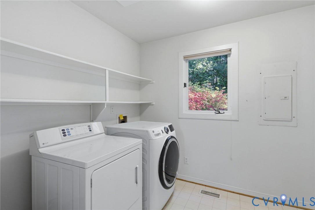 Laundry room, storage above, connects to garage.